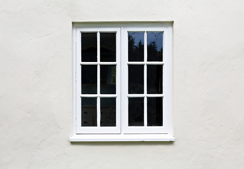 Boarded old window with broken glass panels