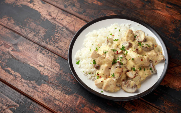 istock Creamy Chicken and mushroom with white rice 1299590085