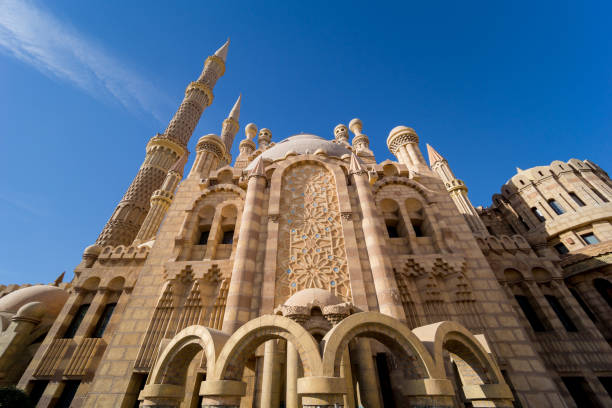 istock Beautiful large Islamic mosque at the sky background 1299590353