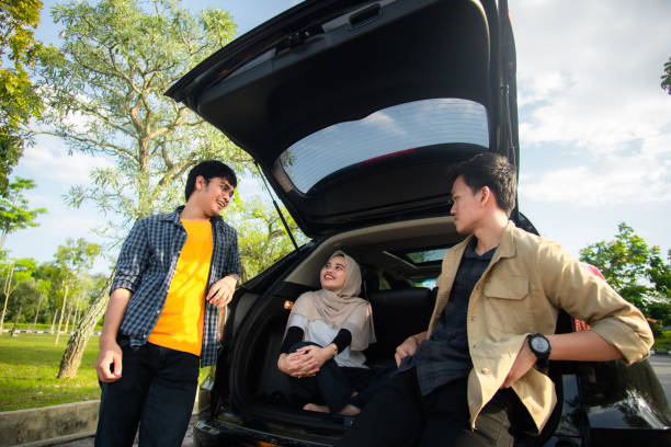 istock Group of People Talking outside the car 1299590458