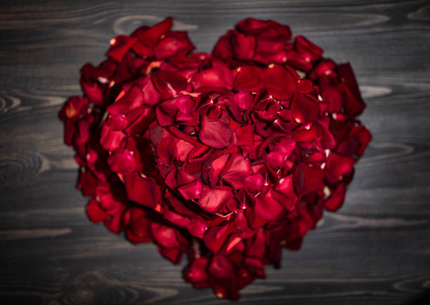 istock Shape of heart from red rose petals 1299591370
