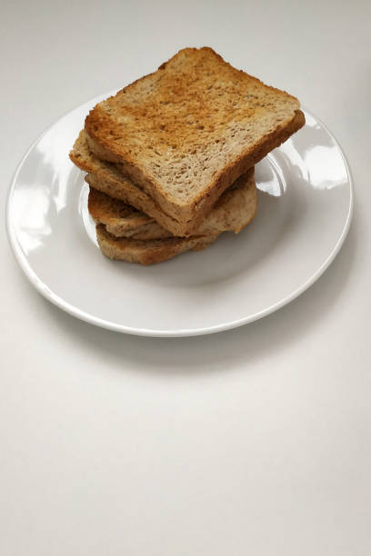 istock Square crispy and fragrant toast on a white plate, toast for breakfast. 1299592731