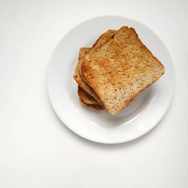 istock Square crispy and fragrant toast on a white plate, toast for breakfast. 1299592755
