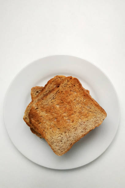 istock Square crispy and fragrant toast on a white plate, toast for breakfast. 1299592807