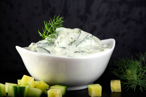 Cucumber yogurt salad Cucumber yogurt salad with herbs tzatziki stock pictures, royalty-free photos & images