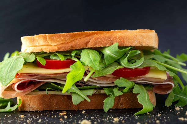 istock Sandwich with prosciutto, cheese , tomatoes and aragula 1299592940