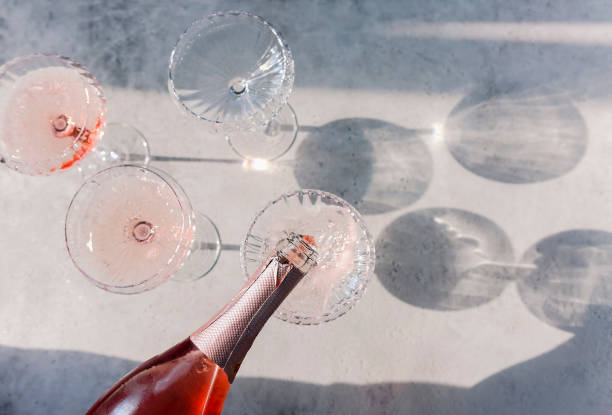 Glasses with cold pink champagne placed on table Glasses with cold pink champagne placed on table in a summer day crystal chalice stock pictures, royalty-free photos & images