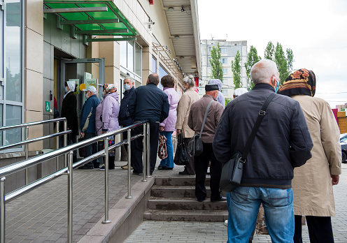 Russia, Voronezh - May 18, 2020: Queue of people on the street at the entrance to the building Aksioma center