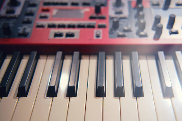 istock Black and white electronic piano keys, red modern synthesizer with sliders and buttons 1299595370