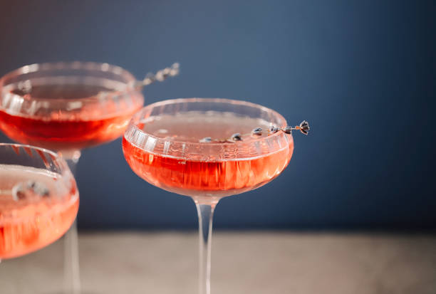 Glasses with cold pink champagne placed on table Glasses with cold pink champagne with lavender flowers placed on table crystal chalice stock pictures, royalty-free photos & images