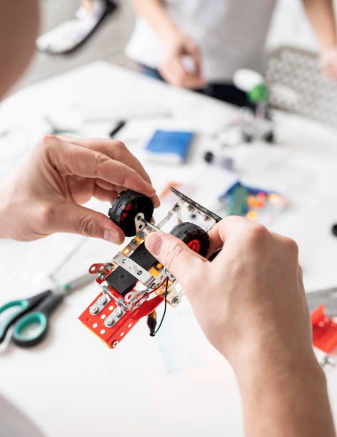 istock male hands constructing robot cars at the workshop 1299595716