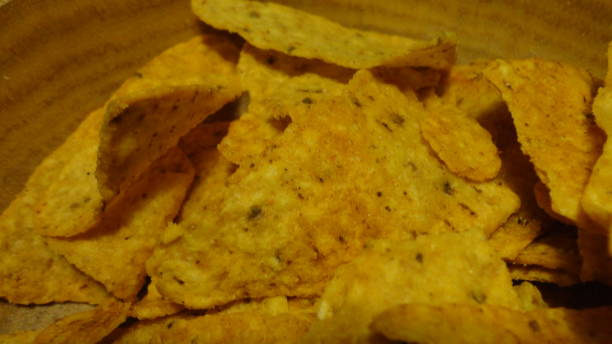 istock Mexican nachos chips in a wooden bowl. 1299596561