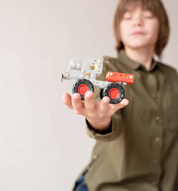 istock boy holding a toy car in his hand 1299596618