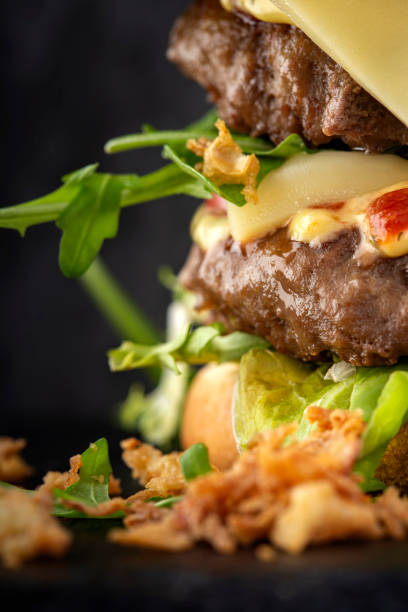 istock Double cheeseburger with a lot of arugula and sauces 1299597508