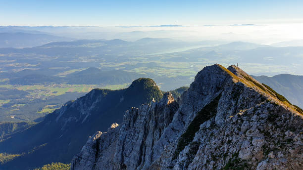 istock Mittagskogel - Panoramic view on the haze shrouded valley from the way to Mittagskogel in Austrian Alps. Clear and sunny day. 1299598039