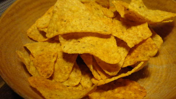 istock Mexican nachos chips in a wooden bowl. 1299598723