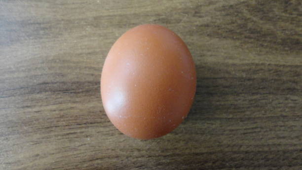 istock Fresh farm eggs on a wooden background. 1299599895