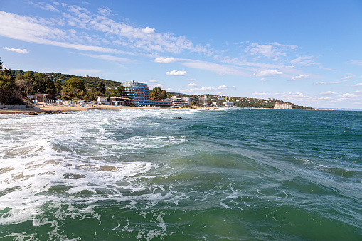 Black Sea coast of Bulgaria Golden Sands. Seascape: sea, blue sky with light clouds, sandy beaches of hotels.