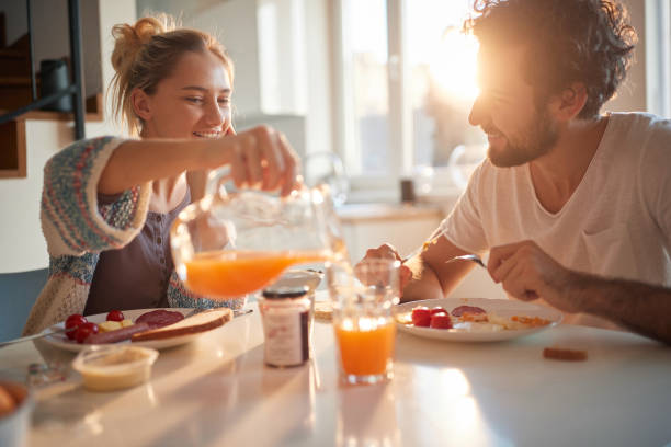 istock Happy couple having breakfast together 1299601706