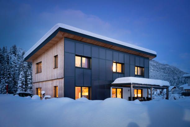 istock Climate-neutral solar house with self-sufficient and sustainable heating and hot water preparation at night in snowy winter 1299602905