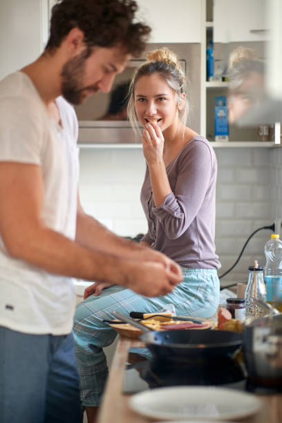 istock A young man preparing a meal for his girlfriend. Cooking, home, kitchen, relationship 1299602985