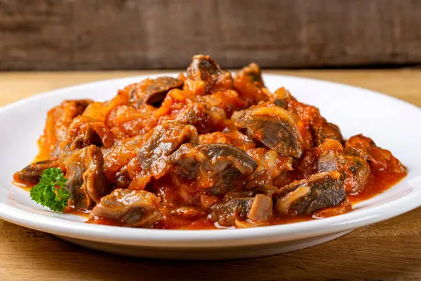 Gizzard stew with tomato sauce on the plate