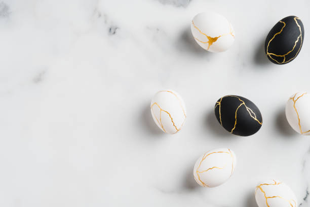 istock Elegant Easter eggs decorated with gold on marble background. Flat lay, top view. Luxury Easter banner template. 1299603324