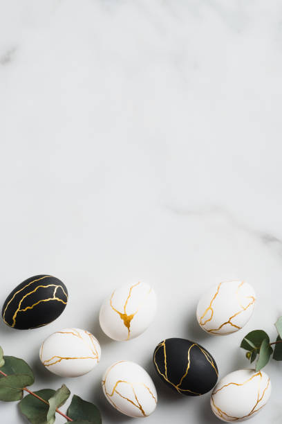 istock Happy Easter vertical banner mockup. Luxury Easter eggs decorated gold and eucalyptus leaves on marble background. Flat lay, top view. 1299603338