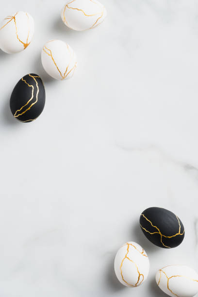 istock Happy Easter greeting card, vertical banner mockup. Elegant black and white Easter eggs decorated gold on marble background. Minimal style. 1299603339