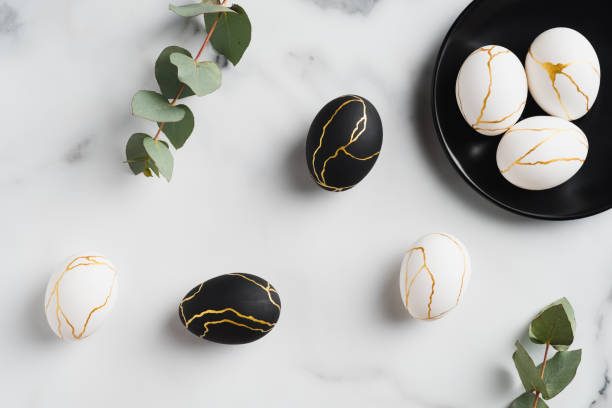 istock Luxury Easter eggs and eucalyptus leaves on marble table. Flat lay, top view. Minimal style. 1299603363
