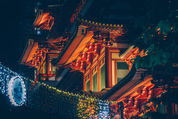 Temple shrine exterior with Lunar Year 2021 decorations seen at night in Chinatown, Singapore, Asia.