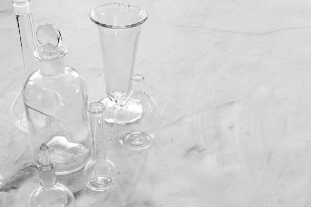 istock Antique laboratory glassware on granite surface black and white with negative space for copy 1299604254