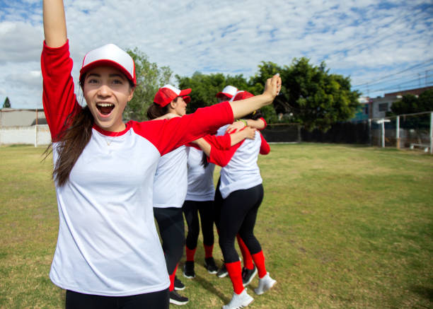 istock Femenil baseball team, celebrating 1299604510