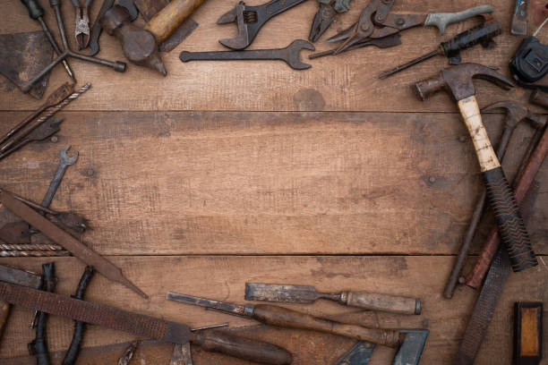 istock Collection of antique woodworking handtools on a rough workbench old wooden 1299604753