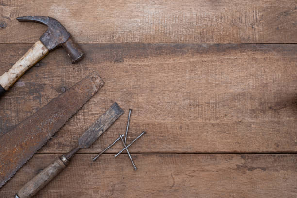 istock Saw hammer and chisel collection of old woodworking handtools on a rough workbench wooden 1299604758