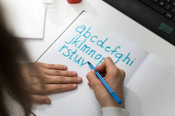 istock Girl drawing the alphabet 1299605644