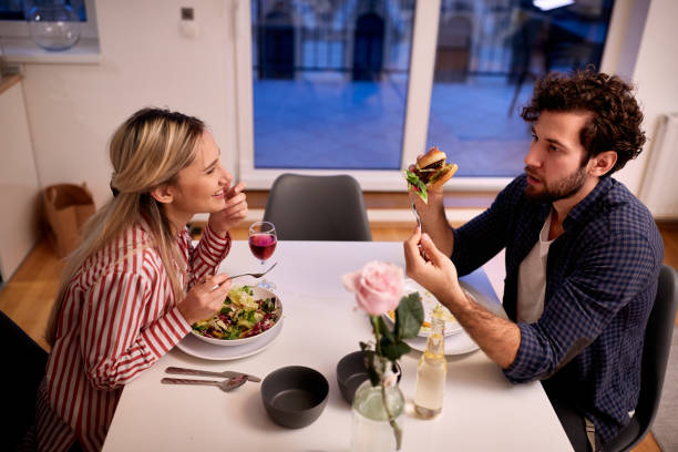 istock A young couple enjoying in a meal together. Home, kitchen, meal, relationship 1299605823
