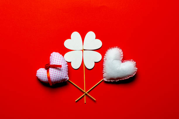 Red textile hearts on wooden sticks for Valentines day background.