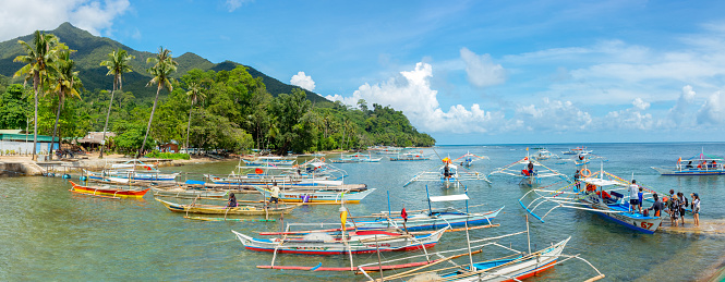 Sabang, Palawan, Philippines - September 26, 2018: traditional Filipino boats at the pier in the village of Sabang.
