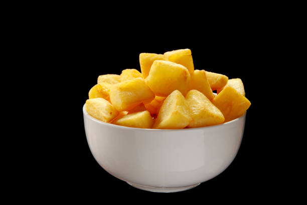 Bravas potatoes Patatas Bravas a Spanish dish of fried cubed potato cuts and served with spicy Paprika Powder and Sauce on a slate and black background patatas bravas stock pictures, royalty-free photos & images