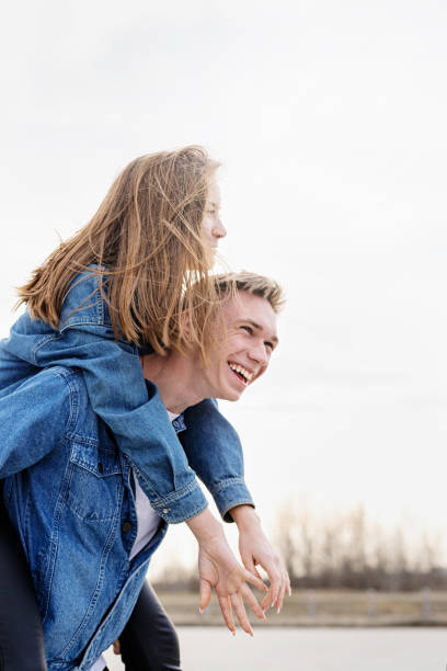 istock Young loving couple spending time together in the park having fun 1299607313