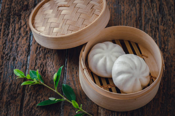 istock Steamed pork buns in bamboo steamer, Chinese dim sum 1299609436