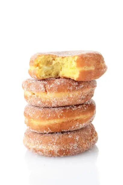 Photo of bite missing from stack of paczki donuts