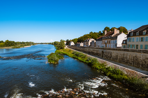 View northwards from the bridge, along the banks of the Loire River of the village of La Charite sur Loire in the Burgundy Region of France.