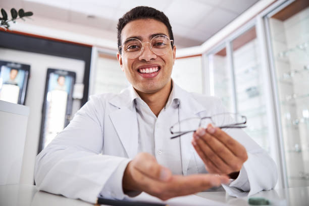istock Cheerful young male optician showing new eyewear 1299613083