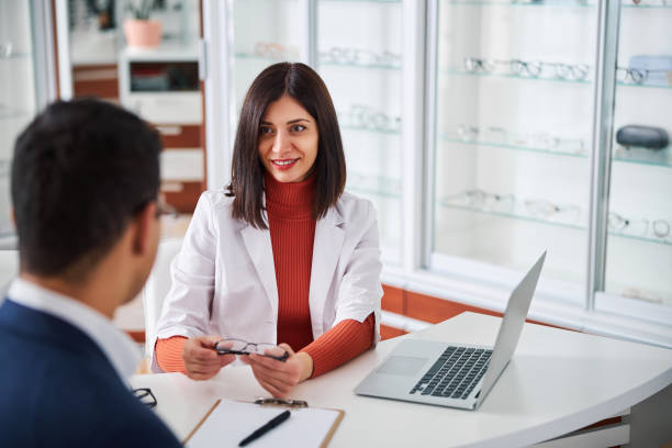 istock Female optometrist showing the eyewear to her client 1299613089