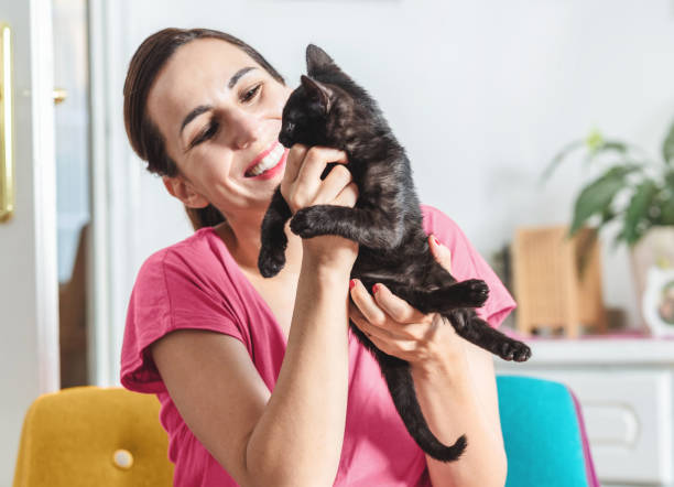 istock Young woman with cat 1299614466