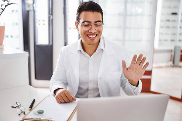 istock Joyous young ophthalmologist greeting his female client 1299614841
