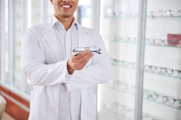 istock Pleased optical dispenser offering new prescription spectacles 1299614848