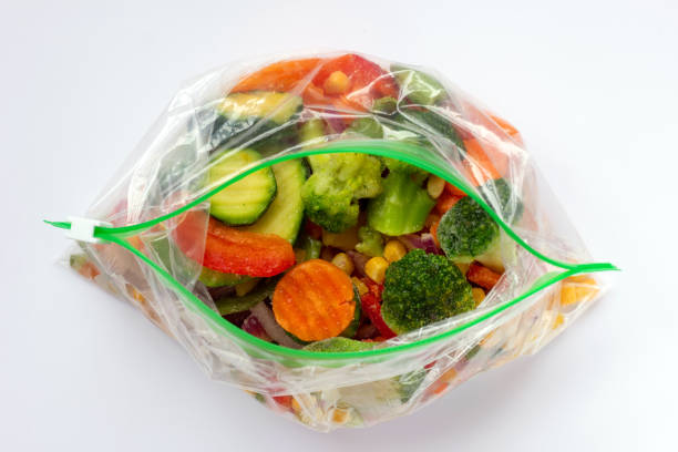 istock Frozen vegetables in plastic bags on white background. 1299617083